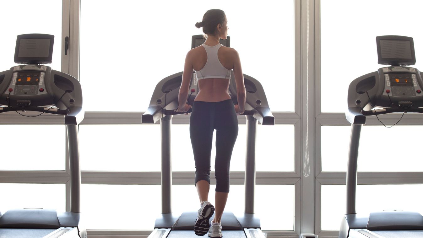 Woman jogging on treadmill at gym