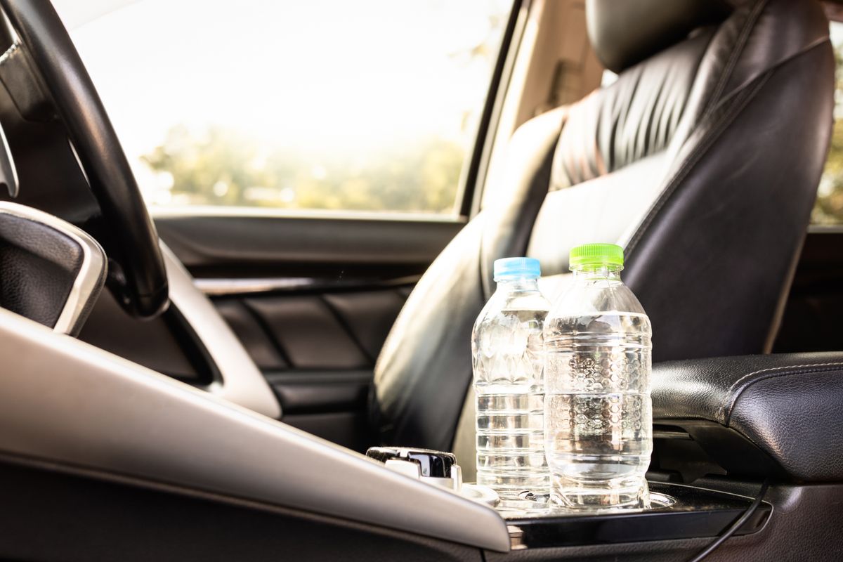 Plastic,Bottle,Of,Water,Placed,On,Car,Seat,And,Exposed