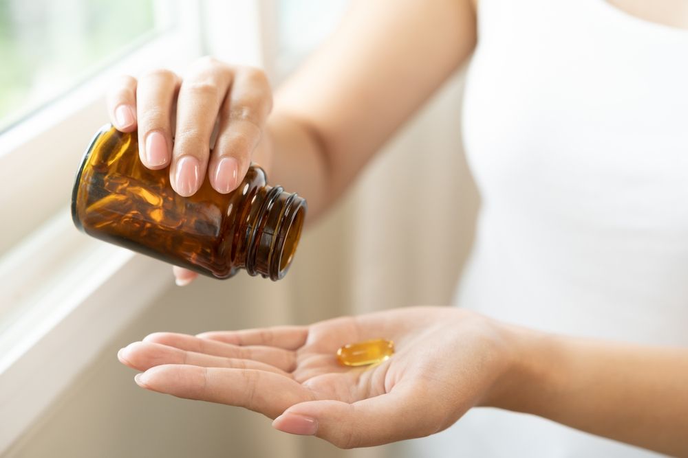 Dietary,Supplement,Concept,,Happy,Asian,Young,Woman,Hand,Holding,Fish