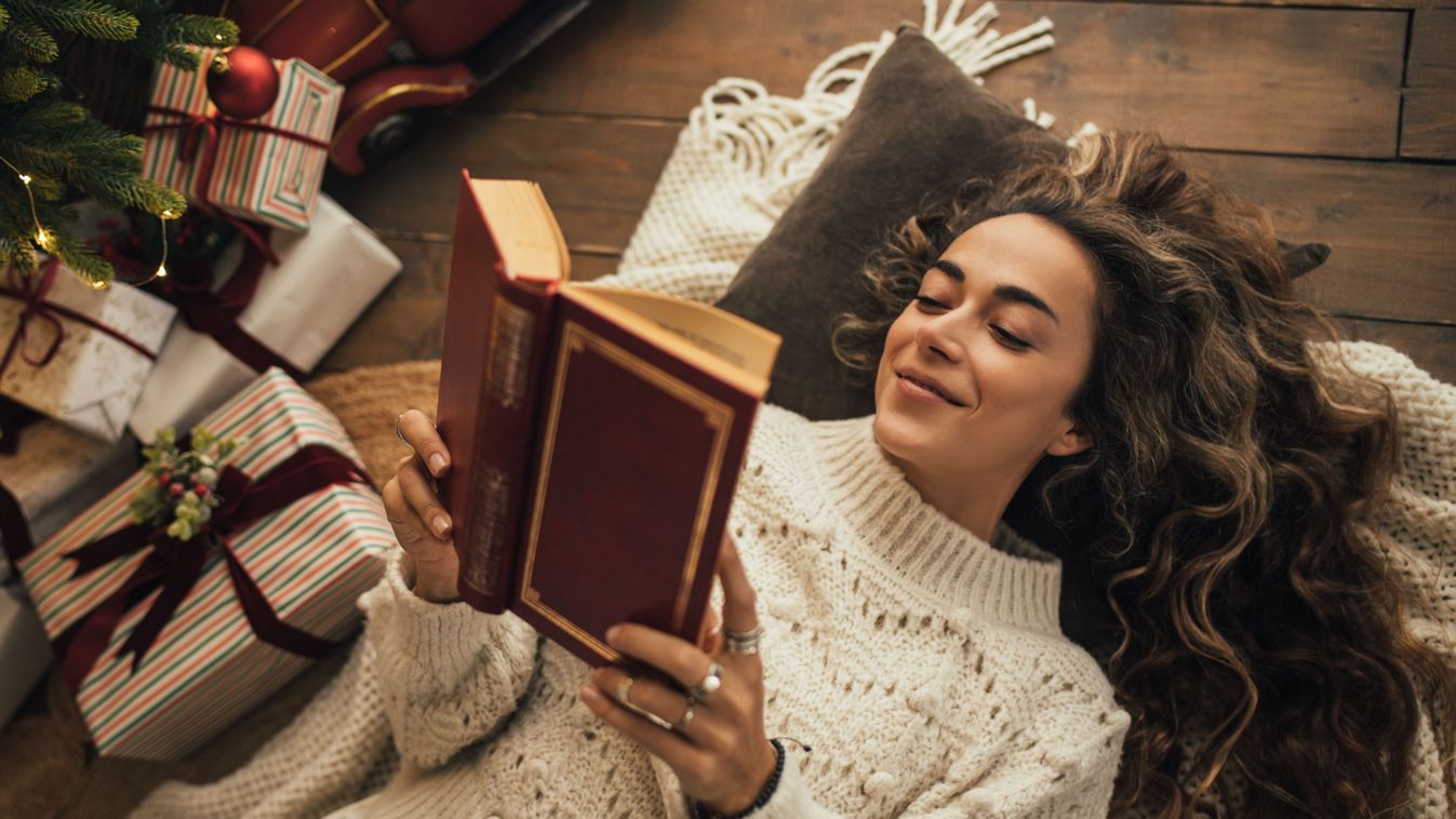 Young,Beautiful,Woman,Reading,Book,,Lying,Near,Christmas,Tree,In