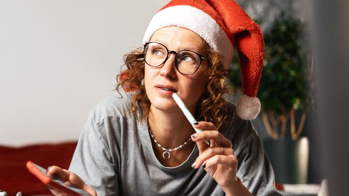 Woman,In,New,Year's,Cap,Lying,On,Bed,And,Writing