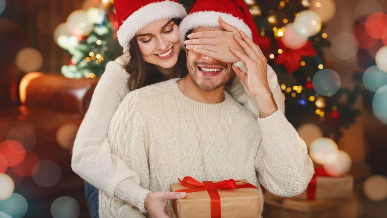 Loving,Young,Woman,Giving,Surprise,Gift,To,Her,Husband,,Closing