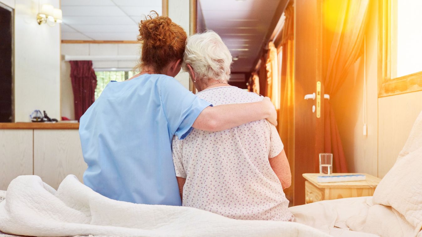 Nurse,In,Hospice,Hugs,Elderly,Woman,On,Bed,For,Comfort