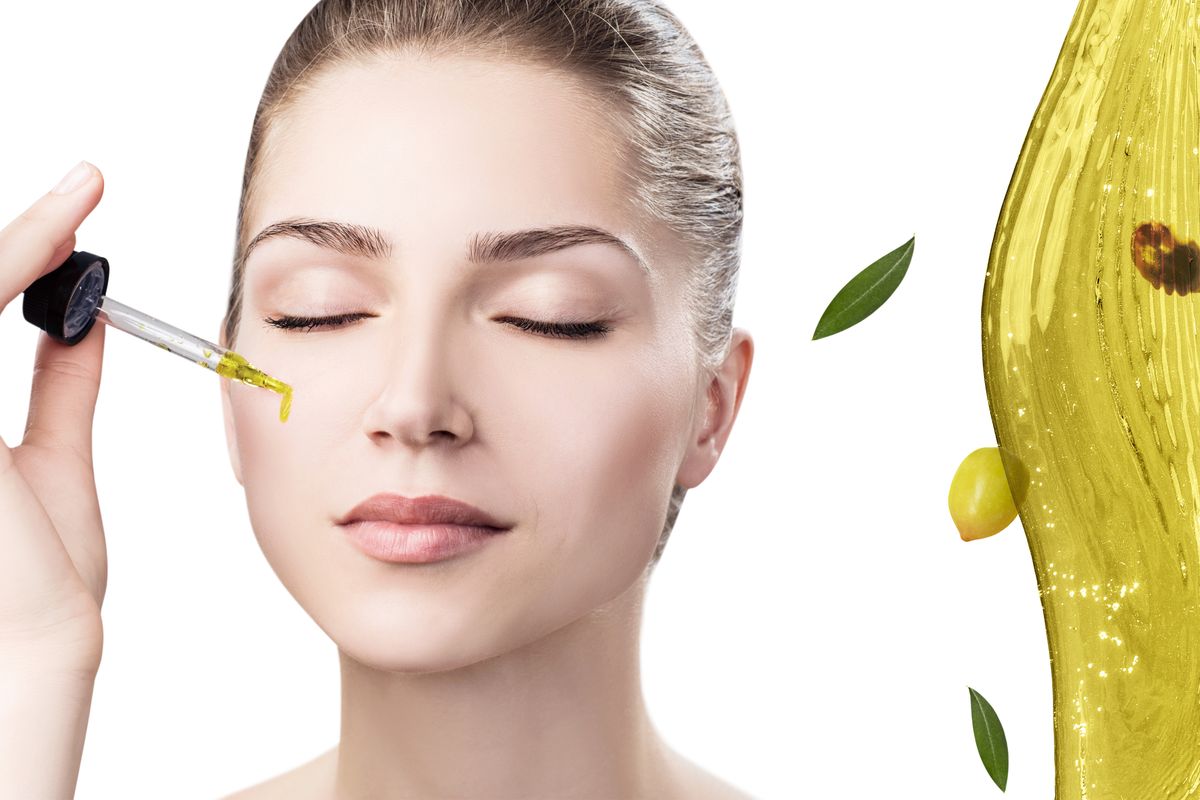 Young,Beautiful,Woman,Near,Splash,Of,Olive,Oil.,Skincare,Concept.