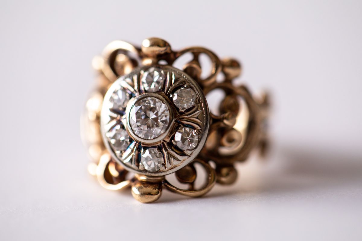 Vintage,Gold,Ring,With,An,Intricate,Design,And,Multiple,Diamonds