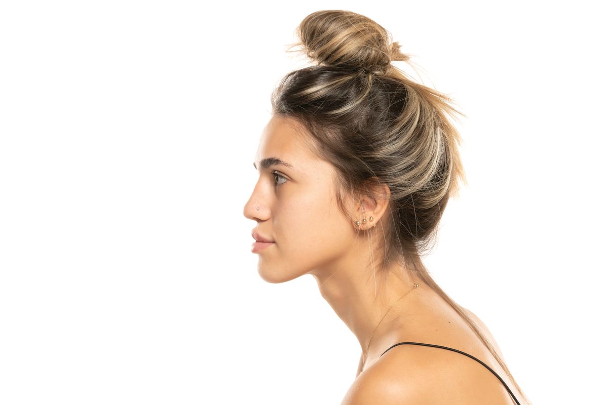 Young,Woman,With,Messy,Loose,Bun,And,No,Makeup,On