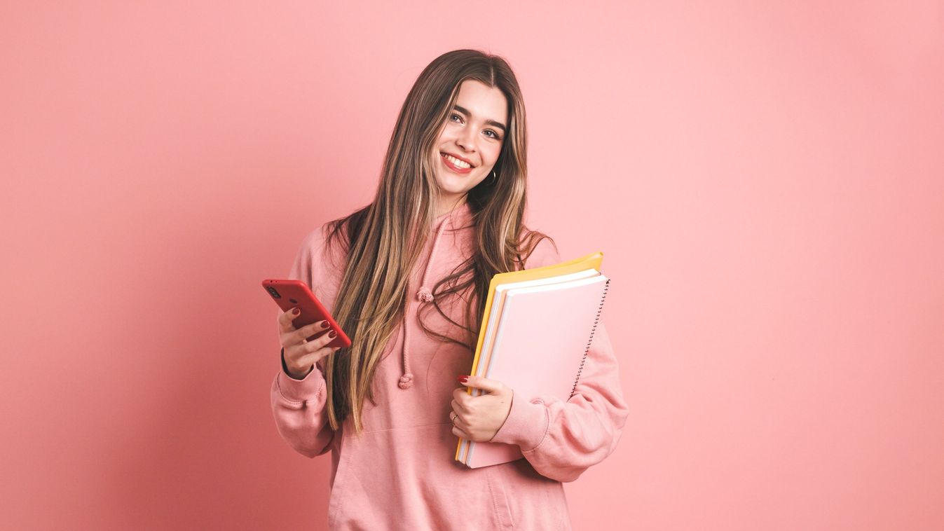 Confident,Female,University,Student,Holding,Books,And,Smartphone