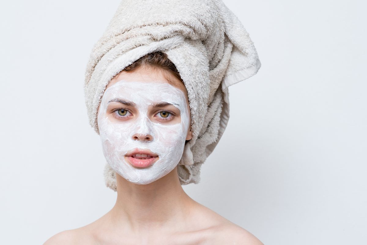 Woman,On,A,White,Background,With,A,Towel,On,Her