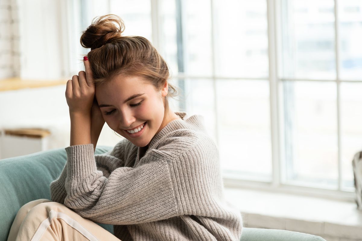 Portrait,Of,Sweet,Smiling,Young,Woman,In,Homewear,Sitting,On