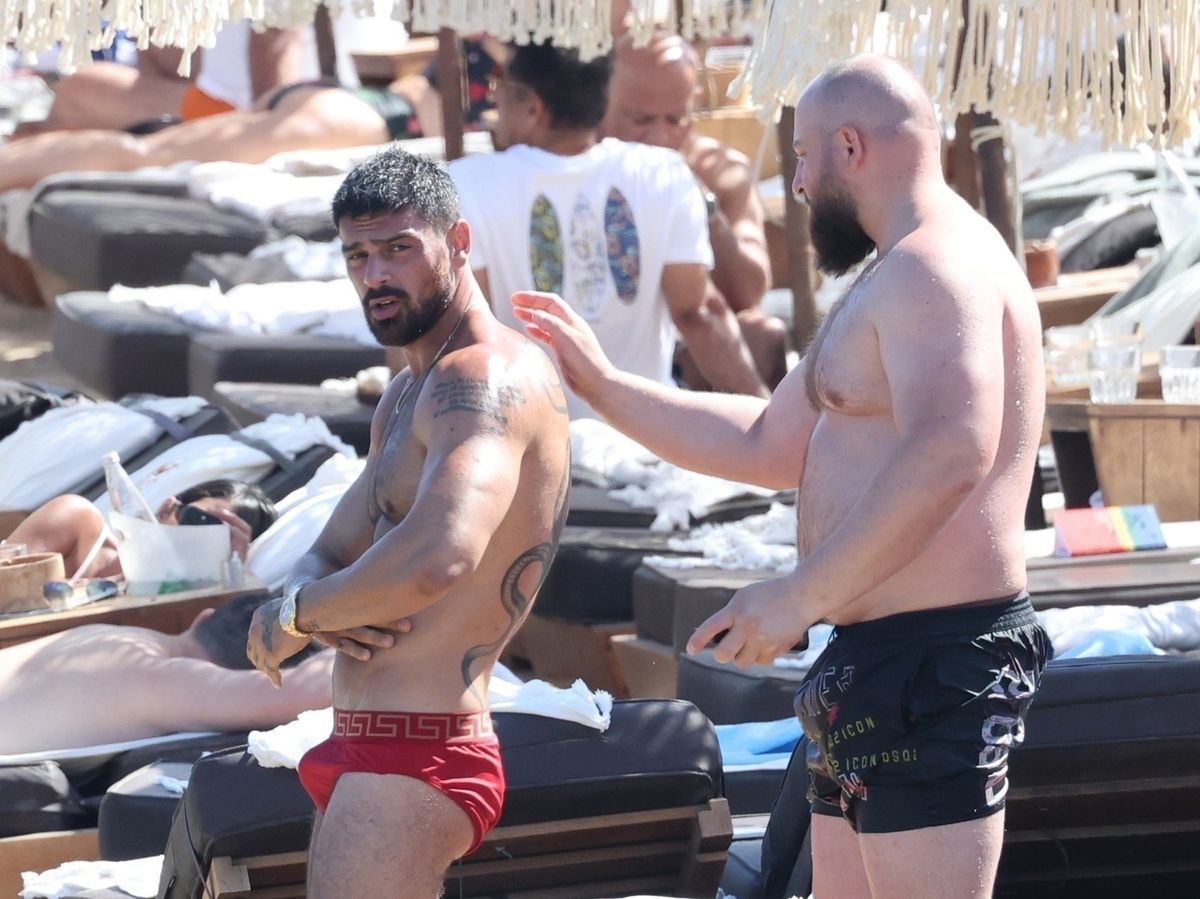 *EXCLUSIVE* The Italian actor, model, singer, and fashion designer Michele Morrone pictured relaxing on the beach with a friend during his holiday in Mykonos.