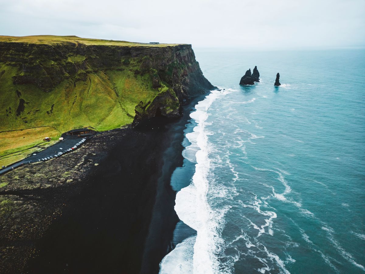 Reynisdrangar rocks on coastline of Reynisfjara black beach, Iceland