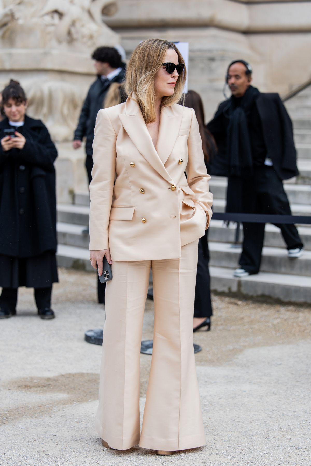 PARIS, FRANCE - MARCH 10: Melissa George wears beige suit, matching flared pants outside Zimmermann during the Womenswear Fall/Winter 2025/2026 as part of Paris Fashion Week on March 10, 2025 in Paris, France. (Photo by Christian Vierig/Getty Images)