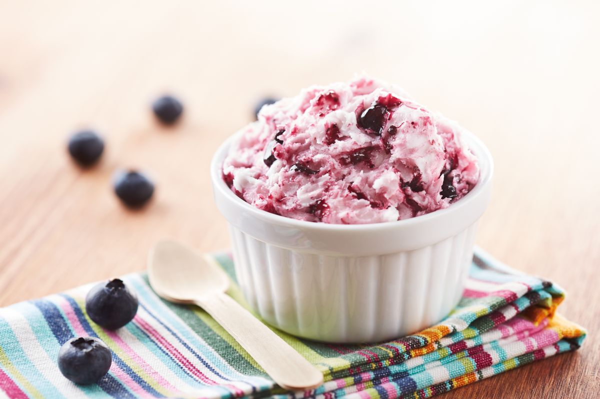 Blueberry ice cream in a white bowl