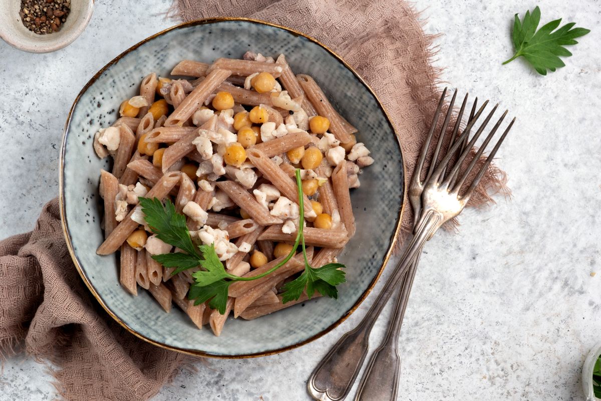 Spelt penne pasta with chicken and chickpeas. Healthy lunch or dinner meal
