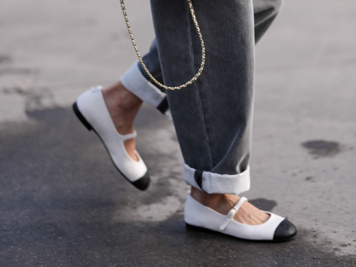 PARIS, FRANCE - MARCH 11: A guest wears white quilted Chanel leather bag, white black toe mary jane flats Chanel leather shoes, outside Chanel, during the Paris Fashion week Women's Fall/Winter 2025-2026 on March 11, 2025 in Paris, France. (Photo by Edward Berthelot/Getty Images)