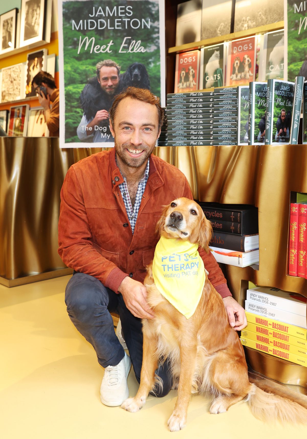 LONDON, ENGLAND - OCTOBER 05: James Middleton poses with a therapy dog in the Taschen Store during Chelsea Dog Day 2024 in support of Pets As Therapy on October 5, 2024 in London, England. (Photo by Hoda Davaine/Dave Benett/Getty Images)