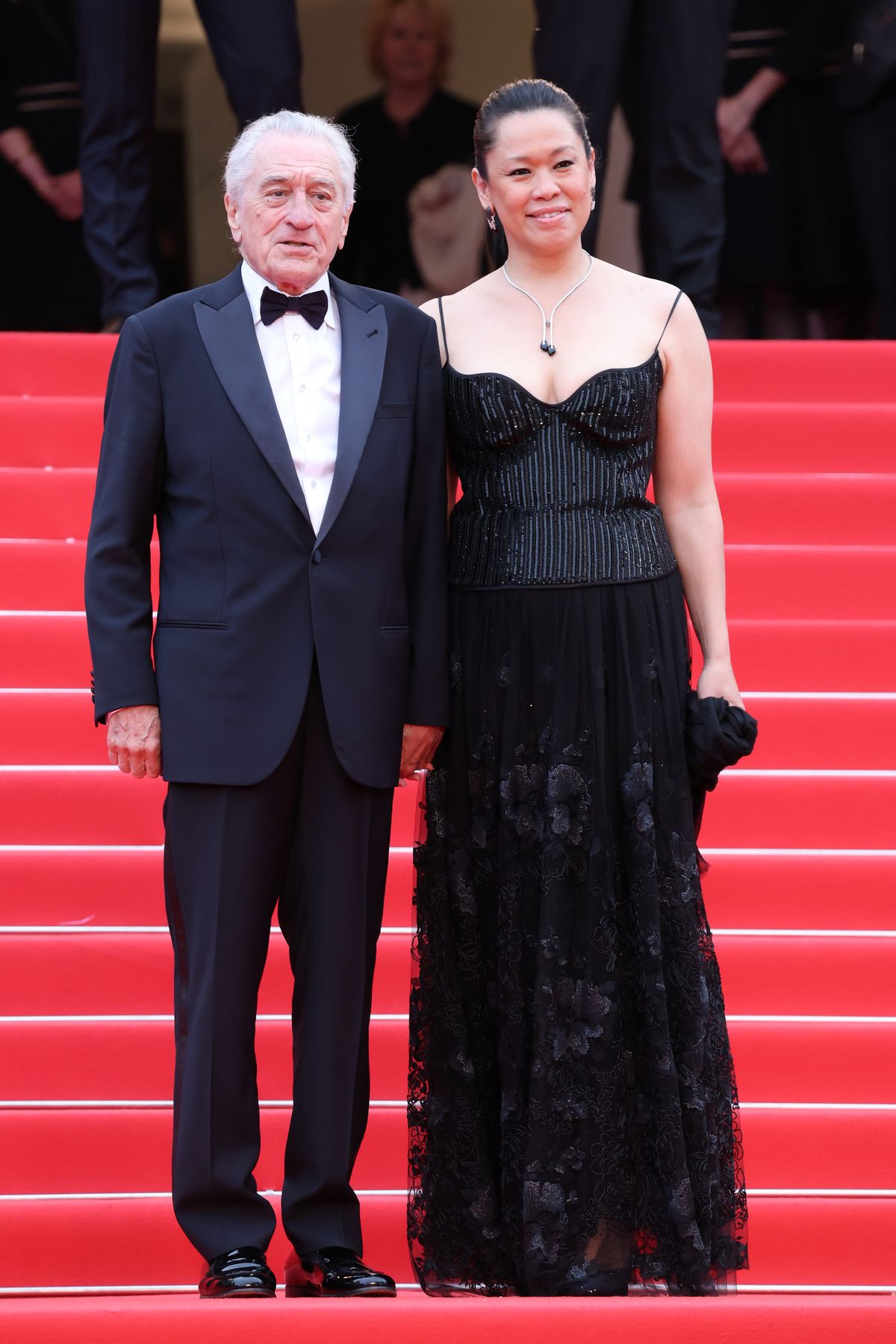 CANNES, FRANCE - MAY 13: Robert De Niro and Tiffany Chen  attend the red carpet for the opening ceremony and "Partir Un Jour" (Leave One Day) screening at the 78th annual Cannes Film Festival at Palais des Festivals on May 13, 2025 in Cannes, France. (Photo by Daniele Venturelli/WireImage)