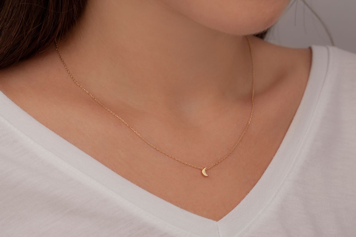 Silver necklace on a well-groomed lady. Product image that can be used in e-commerce, social media, online sales. Jewelry photo with woman jewelry concept.