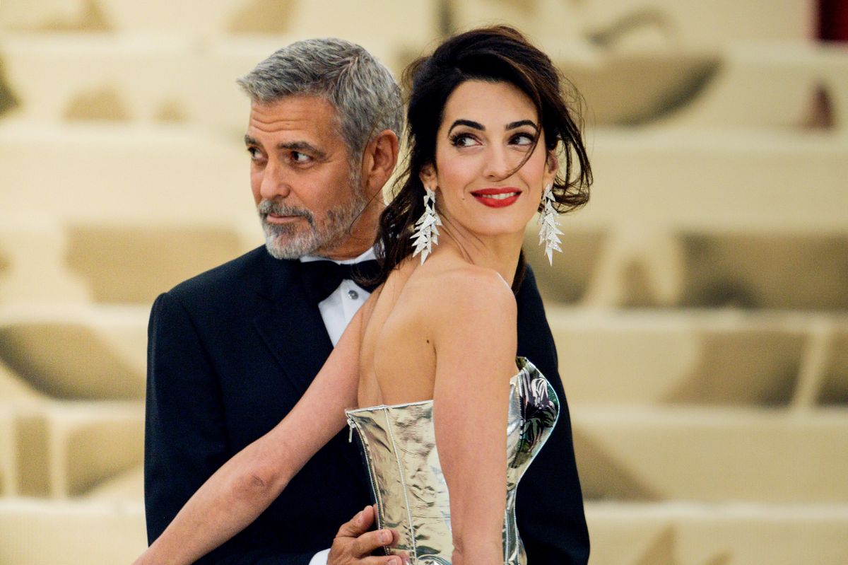 NEW YORK, NY - MAY 07:  Actor George Clooney (L) and lawyer Amal Clooney enter the Heavenly Bodies: Fashion & The Catholic Imagination Costume Institute Gala at The Metropolitan Museum on May 07, 2018 in New York City.  (Photo by Ray Tamarra/GC Images)