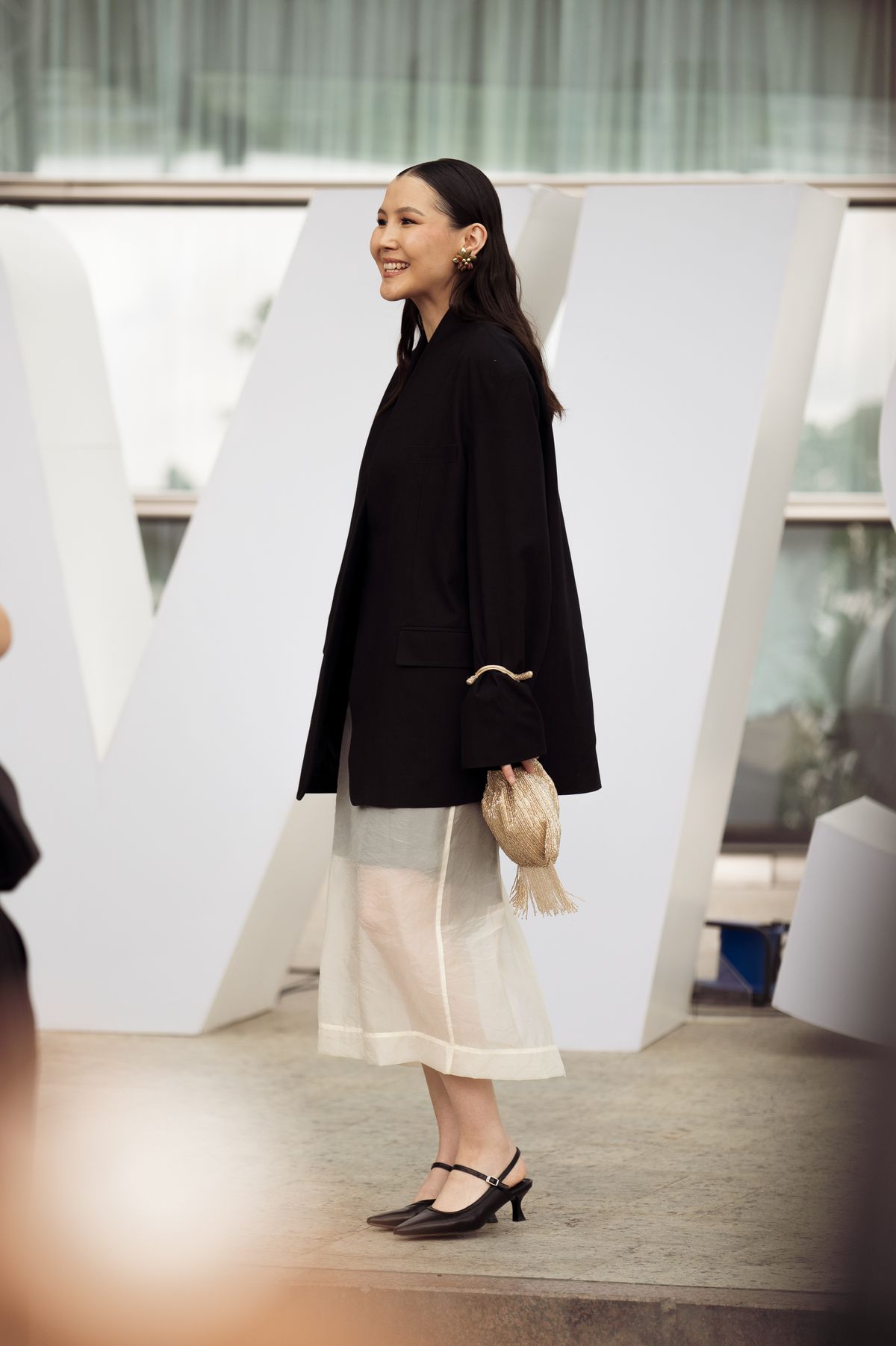 ALMATY, KAZAKHSTAN - MAY 05: A guest wears beige sheer skirt, black oversized jacket and black shoes during day 3 of Visa Fashion Week Almaty 2025 on May 05, 2025 in Almaty, Kazakhstan. (Photo by Raimonda Kulikauskiene/Getty Images)
