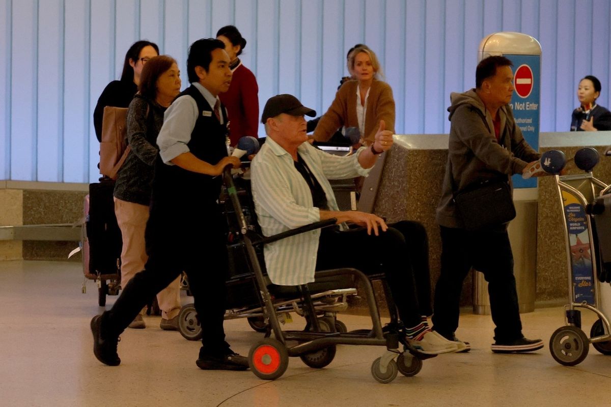 Los Angeles, CA  - *PREMIUM-EXCLUSIVE*  - David Hasselhoff is spotted in a wheelchair at LAX. The Hoff was arriving to California from Mexico with his wife Hayley Roberts. Wearing a striped shirt and baseball cap, David was wheeled through the terminal by an airpot worker to where his limo driver was waiting. He then eased out of the chair to walk the rest of the way, leaning heavily on Hayley. The 'Baywatch' star was eager to give the thumbs up and reassure waiting photographers he was okay, explaining that he needed a knee operation.

*UK Clients - Pictures Containing Children
Please Pixelate Face Prior To Publication*,Image: 996313684, License: Rights-managed, Restrictions: , Model Release: no, Pictured: David Hasselhoff, Hayley Roberts