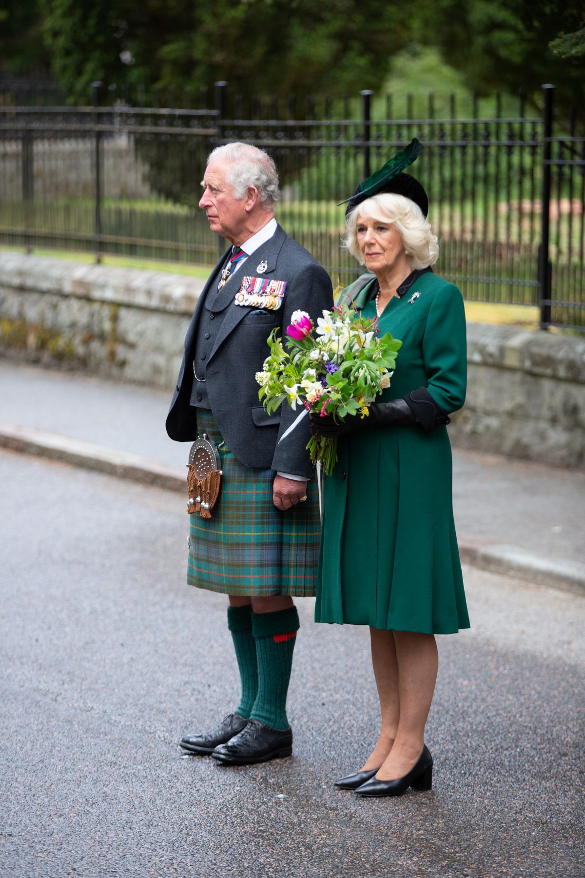 CRATHIE, SCOTLAND - MAY 8: In this picture released by Clarence House,  Prince Charles, Prince of Wales and Camilla, Duchess of Cornwall (known as the Duke and Duchess of Rothesay when in Scotland) observe a two minute silence to mark the 75th anniversary of VE Day at the Balmoral War Memorial on May 8, 2020 near Crathie, United Kingdom.   During the event the Prince of Wales laid a wreath and the Duchess of Cornwall placed flowers at the memorial. The UK commemorates the 75th Anniversary of Victory in Europe Day (VE Day) with a pared-back rota of events due to the coronavirus lockdown. On May 8th, 1945 the Allied Forces of World War II celebrated the formal acceptance of surrender of Nazi Germany.   (Photo by Amy Muir/WPA Pool/Getty Images)