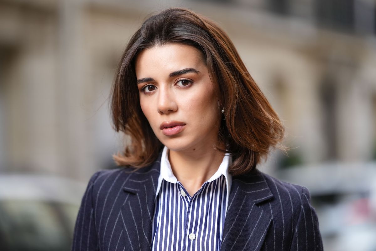 PARIS, FRANCE - MAY 07: Katie Degas @katie.one wears a blue and white striped shirt, a blazer jacket, during a street style fashion photo session, on May 07, 2025 in Paris, France. (Photo by Edward Berthelot/Getty Images)