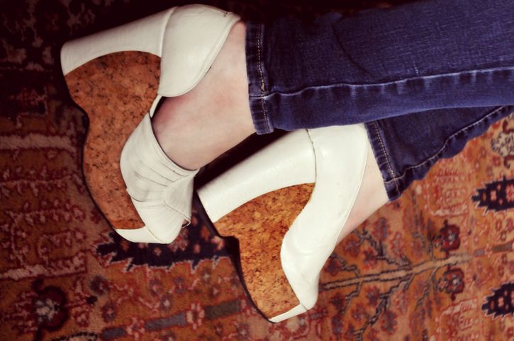 A young woman's feet in vintage high heels and wearing jeans