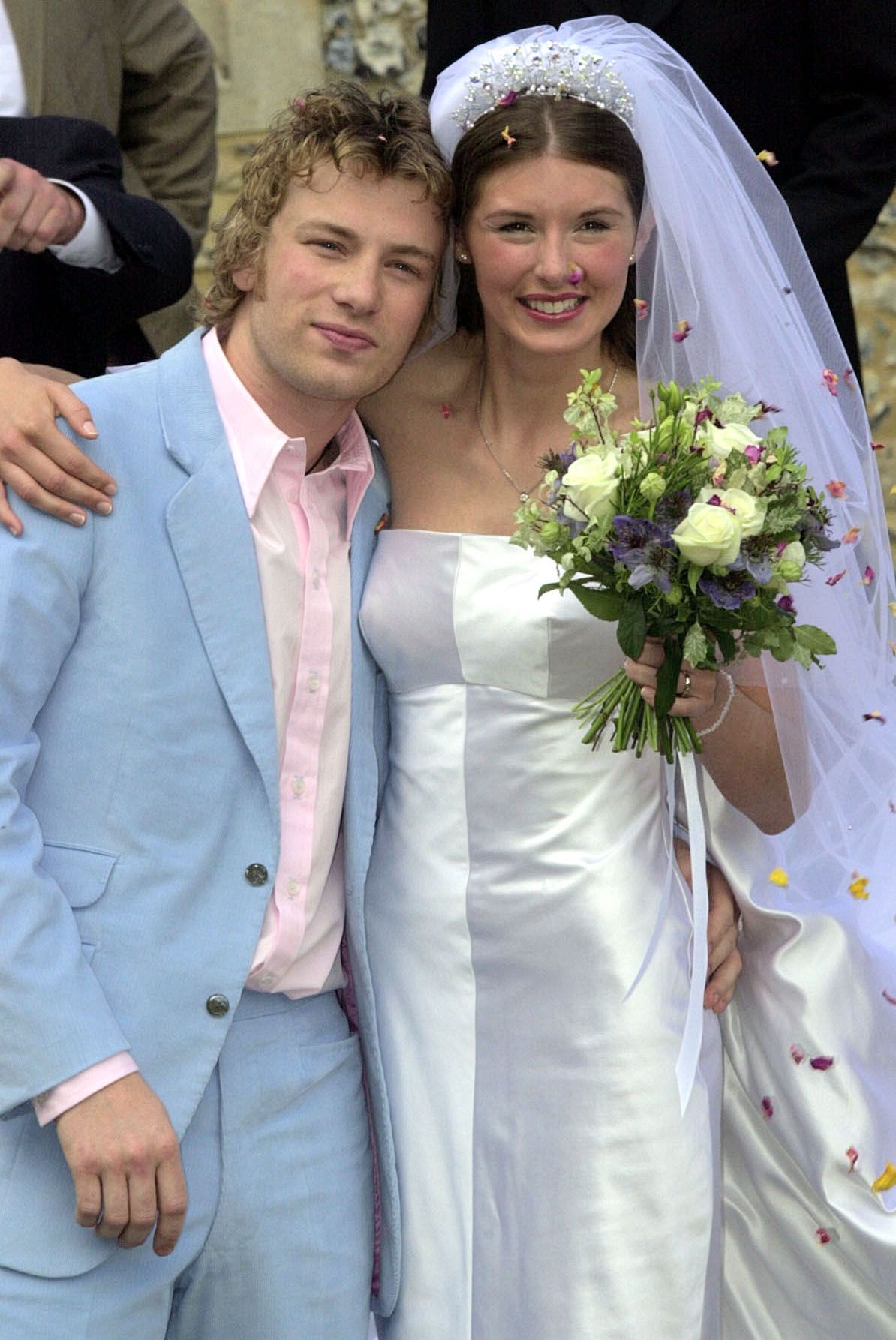 Celebrity television chef Jamie Oliver, wearing a Paul Smith suit, and his bride Juliette Norton (Jools) after their wedding ceremony, outside the All Saints Church , Rickling, in Essex. The happy couple,  both 25, have known each other for over a decade.  * ...and now both their personal and professional lives are inter linked as Jools works as Jamie's PA.   (Photo by Tim Ockenden - PA Images/PA Images via Getty Images)
