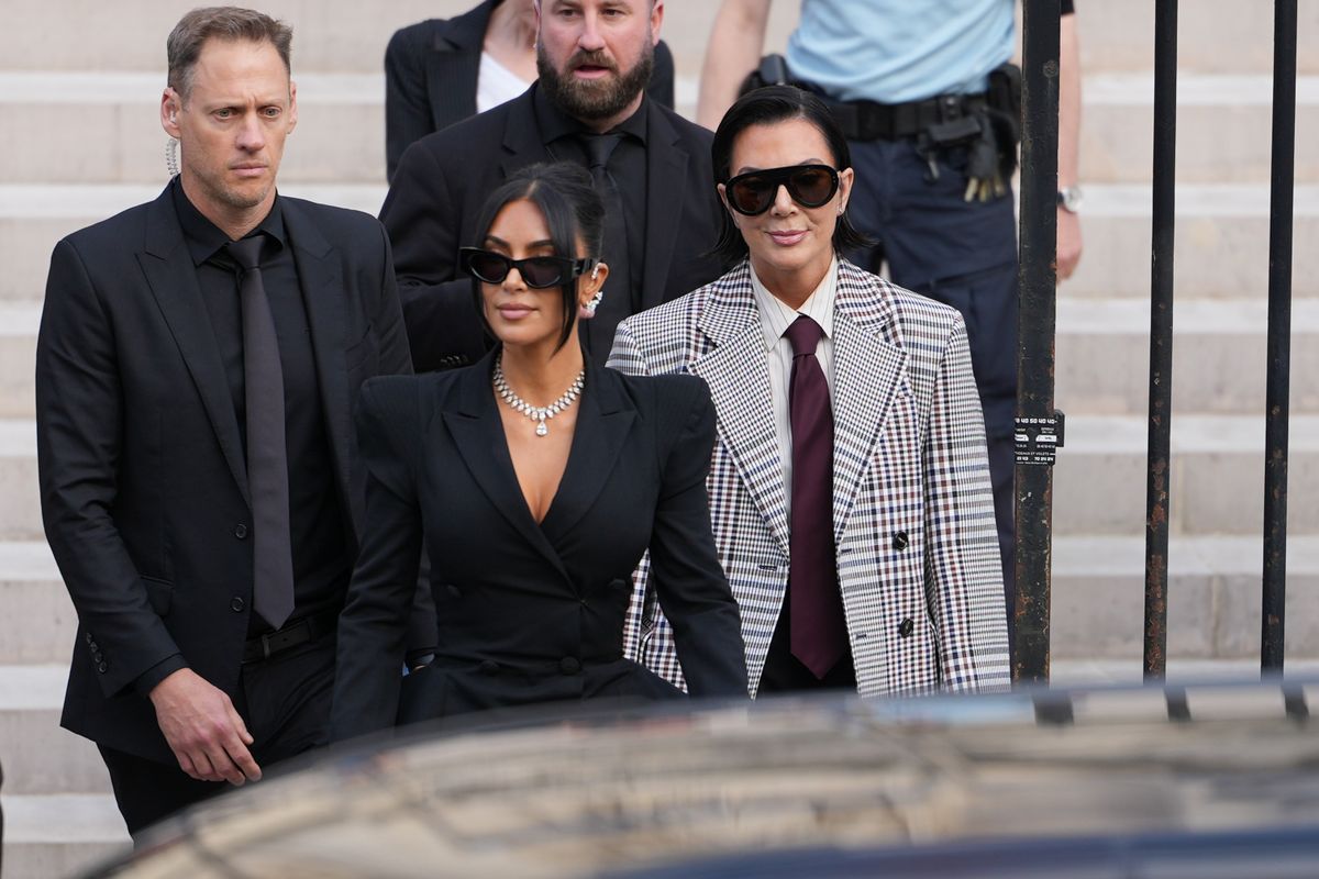 PARIS, FRANCE - MAY 13: Kim Kardashian and Kris Jenner exit the trial at the Palais de Justice ; Kim Kardashian wears sunglasses by Alaia, a black dress with power shoulders / shoulder pads / puff shoulders and low-neck by John Galliano, a necklace by Samer Halimeh, Repossi diamond earcuffs, Brioni Raymond earrings, at the Palais de Justice, on May 13, 2025 in Paris, France. (Photo by Edward Berthelot/GC Images)