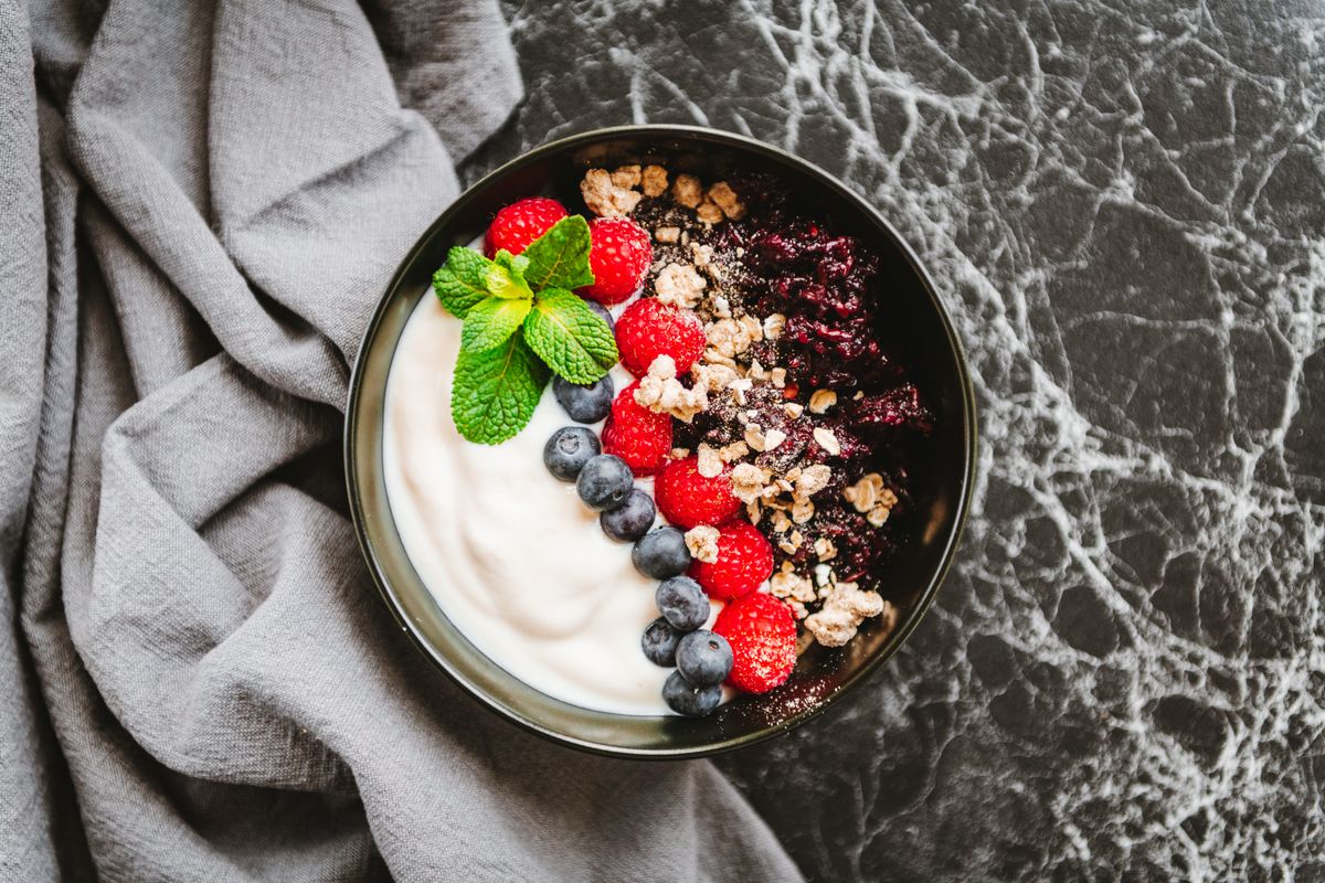 Delicious fruit bowl with black rice and yoghurt