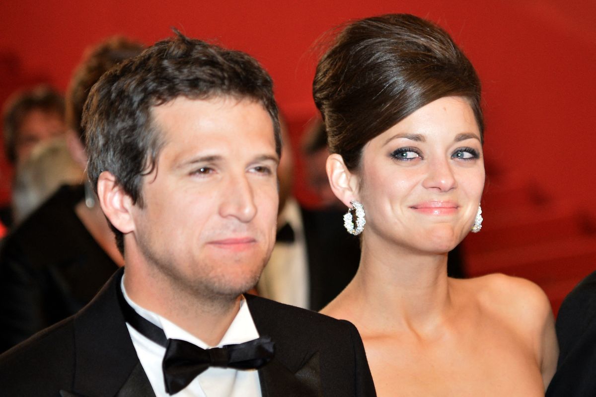 (FILES) French actress Marion Cotillard (R) looks at her partner director Guillaume Canet  as they leave after attending the screening of the film "Blood Ties" presented Out of Competition at the 66th edition of the Cannes Film Festival in Cannes on May 20, 2013. French film stars Marion Cotillard and Guillaume Canet announced their separation on June 27, 2025 via a communique sent by their entourage to AFP. (Photo by Alberto PIZZOLI / AFP)