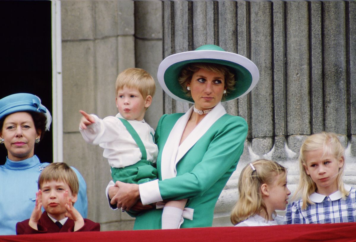 UNITED KINGDOM - JUNE 11:  Diana, Princess of Wales, holding a young Prince Harry in her arms as she watches Trooping the Colour with Prince William, Lady Rose Windsor, Lady Davina Windsor and Princess Margaret from the balcony of Buckingham Palace  (Photo by Tim Graham Photo Library via Getty Images)