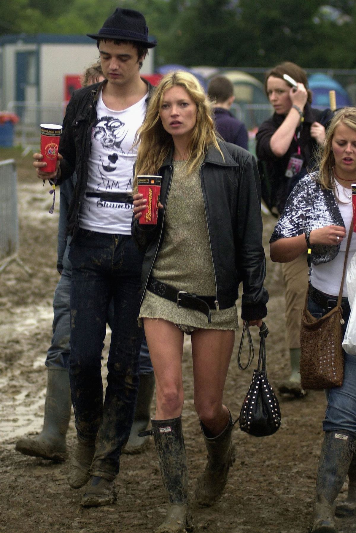 GLASTONBURY, ENGLAND - JUNE 25: Kate Moss and Pete Doherty walk backstage on the second day of the Glastonbury Music Festival 2005 at Worthy Farm, Pilton on June 25, 2005 in Somerset, England. Pete Doherty was at the festival to perform with his band Babyshambles. The festival runs until June 26. (Photo by Matt Cardy/Getty Images)