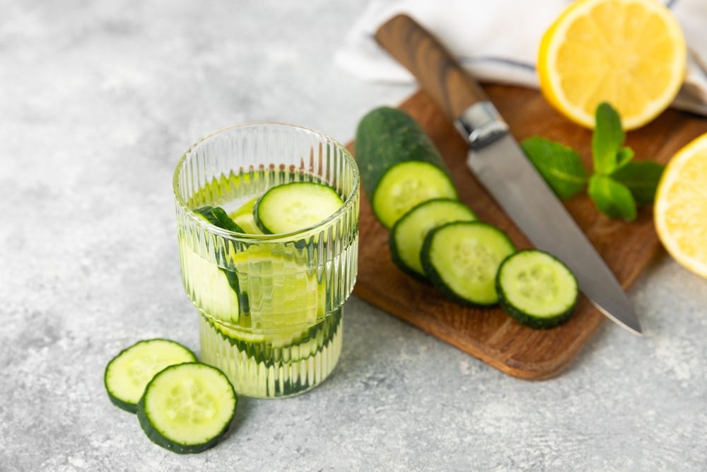 zsírégetés Cucumber water with lemon, lime and mint on a wooden table. Water infused with sliced ​​cucumber in a drinking glass. Tonic refreshing drink. Cucumber lemonade.Summer natural cooling drink.Copy space