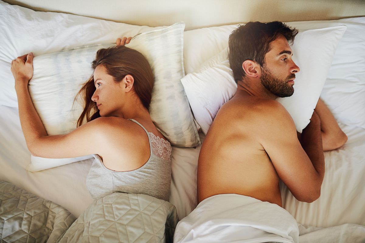 Frustrated couple, bed and argument above with fight, disagreement or erectile dysfunction at home. Top view of man and woman in toxic relationship, breakup or divorce from affair in bedroom at house