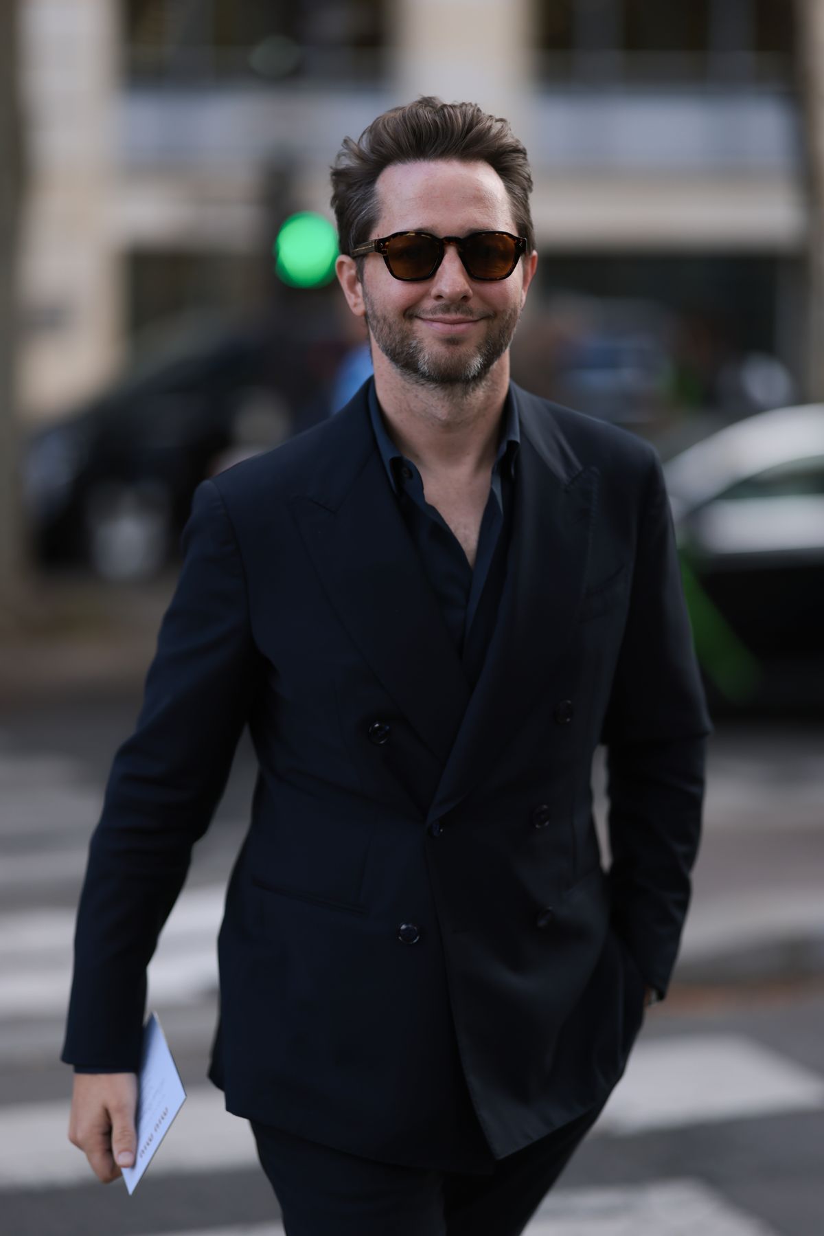 PARIS, FRANCE - OCTOBER 01: Derek C. Blasberg is seen wearing square sunglasses with dark Havana frame from Prada, a black suit jacket with peak lapels and a double-button placket, a dark blue shirt underneath, and black suit pants before the Miu Miu Womenswear Spring/Summer 2025 Show as part of Paris Fashion Week on October 01, 2024 in Paris, France. (Photo by Jeremy Moeller/Getty Images)