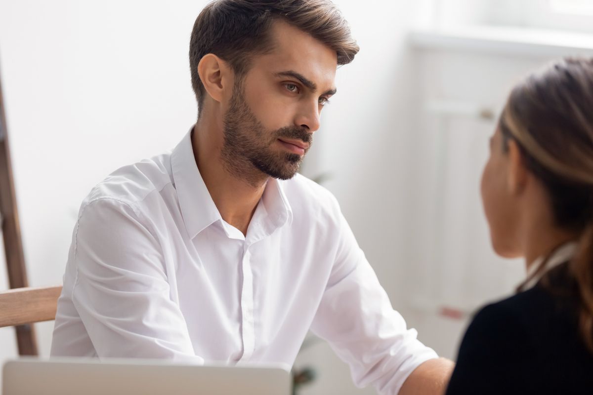 Serious hr manager attentively listening to candidate answering question on job interview in office close up, focused employer doubting, thinking about hiring decision, dishonest applicant or resume