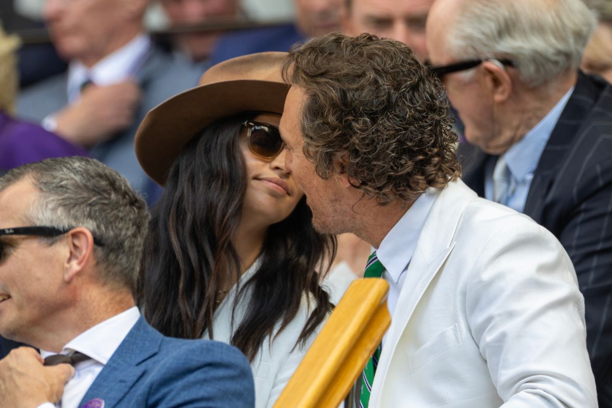 LONDON, ENGLAND - JULY 13: Matthew McConaughey and his wife Camila Alves share a kiss in the Royal Box for the Gentlemen's Singles Final on Centre Court during the Wimbledon Lawn Tennis Championships at the All England Lawn Tennis and Croquet Club at Wimbledon on July 13th, 2025, in London, England. (Photo by Tim Clayton/Getty Images)