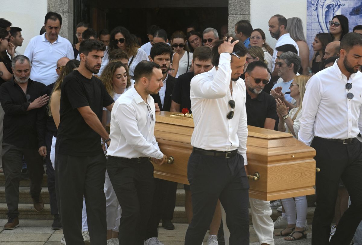 Diogo Jota's wife Rute Cardoso (C) follows the coffin of Portuguese football player Diogo Jota carried out of the church after the funeral ceremony of Liverpool's Portuguese forward Diogo Jota and his brother Andre Silva at the Mother Church of Gondomar, on the outskirts of Porto, on July 5, 2025. Liverpool forward Diogo Jota and his brother died in a car crash in Spain on July 3, 2025, sparking widespread grief just after the Portugal star had got married. (Photo by MIGUEL RIOPA / AFP)