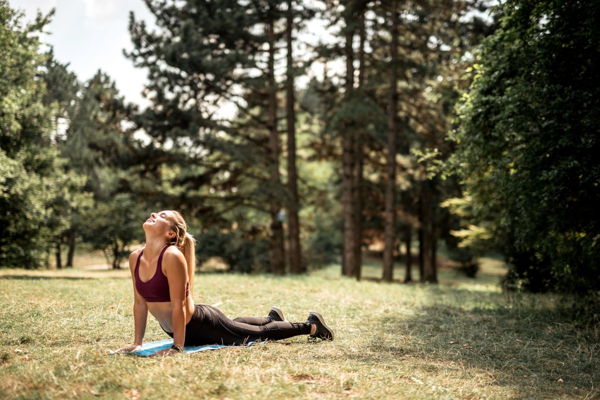 Young pretty fitness sporty woman doing joga outdoor