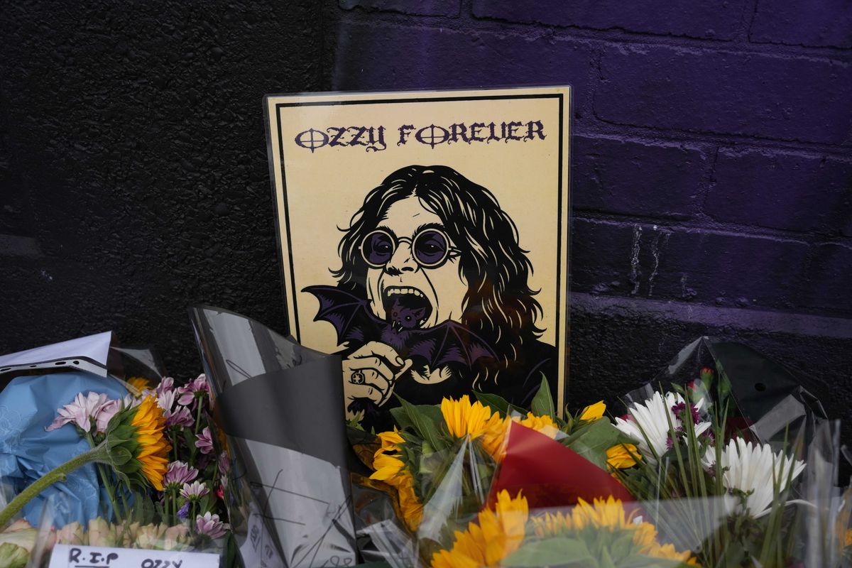 BIRMINGHAM, UNITED KINGDOM - JULY 24: Flowers, notes and floral tributes placed on the Black Sabbath Bridge bench are seen in Birmingham, United Kingdom on July 24, 2025, in memory of Ozzy Osbourne, the iconic frontman of Black Sabbath band and one of the most influential figures in British heavy metal music. Osbourne has died at the age of 76. (Photo by Ioannis Alexopoulos/Anadolu via Getty Images)