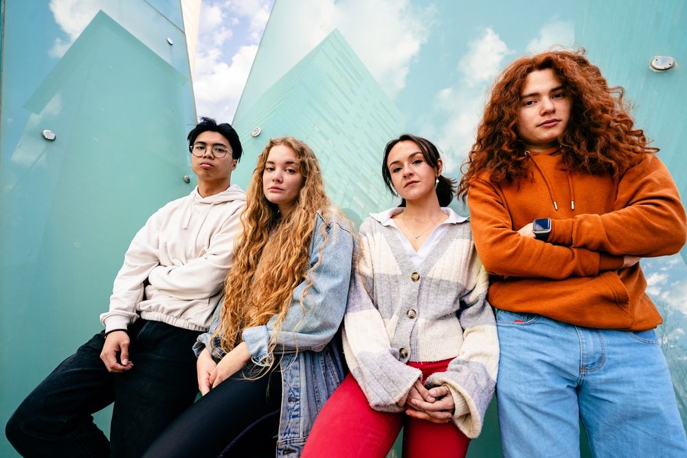 Z generáció Portrait group of young Gen Z friends standing with serious expression in the city