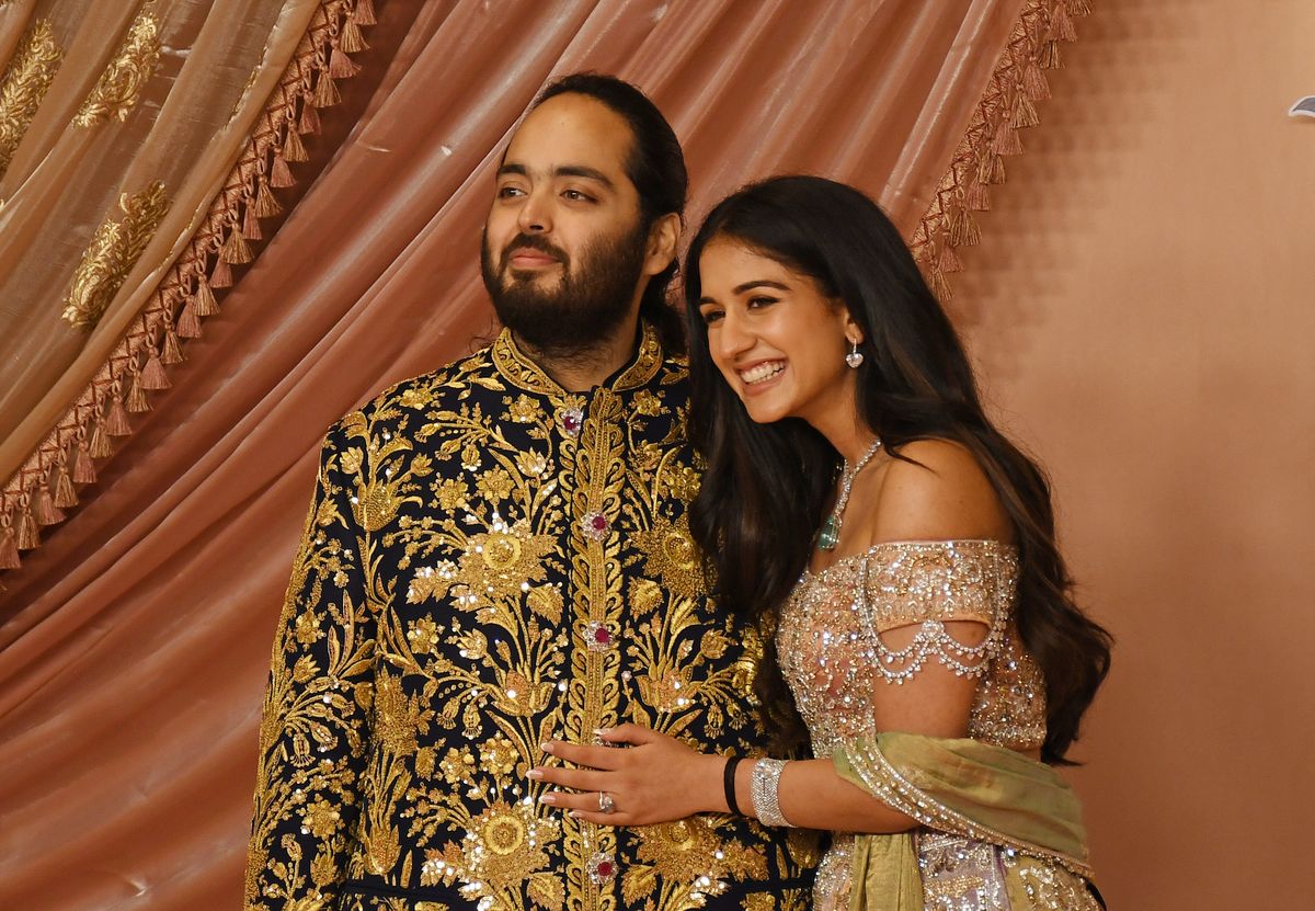 MUMBAI, MAHARASHTRA, INDIA - 2024/07/05: Anant Ambani (son of Indian businessman Mukesh Ambani) and his fiancée Radhika Merchant pose for a photo on the red carpet during the sangeet ceremony at Jio World Centre in Mumbai. (Photo by Ashish Vaishnav/SOPA Images/LightRocket via Getty Images)