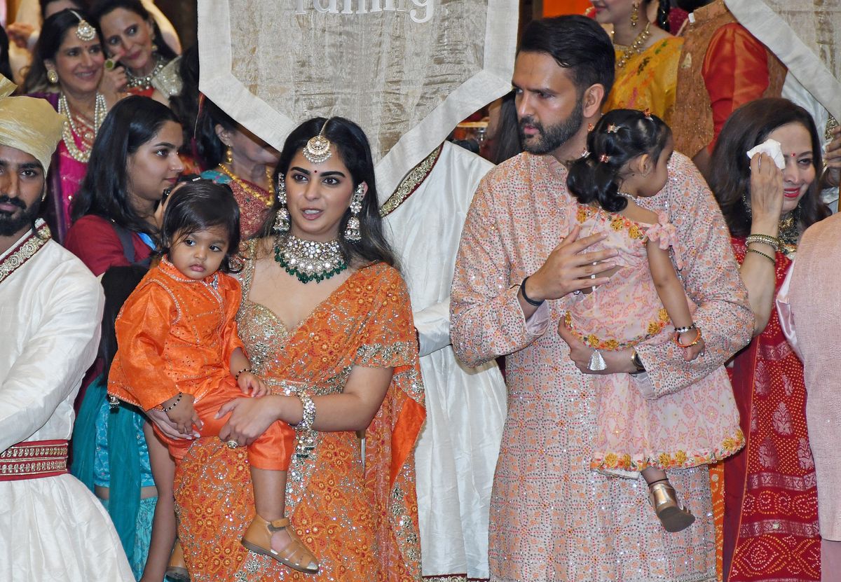July 3, 2024, Mumbai, Maharashtra, India: (L-R) Isha Ambani and Anand Piramal pose for a photo with their children at the 'Mameru' (traditional ceremony in Gujarati culture) ceremony, part of pre wedding celebration of Anant Ambani and Radhika Merchant at Ambani's residence Antilia in Mumbai. 'Mameru' also known as 'Mosalu' (traditional ceremony in Gujarati culture) where the groom's mother's (Nita Ambani) family came to bless the couple along with gifts and offerings. The groom's maternal uncles and family presented the bride and the groom with a traditional set of gifts.,Image: 887222768, License: Rights-managed, Restrictions: , Model Release: no