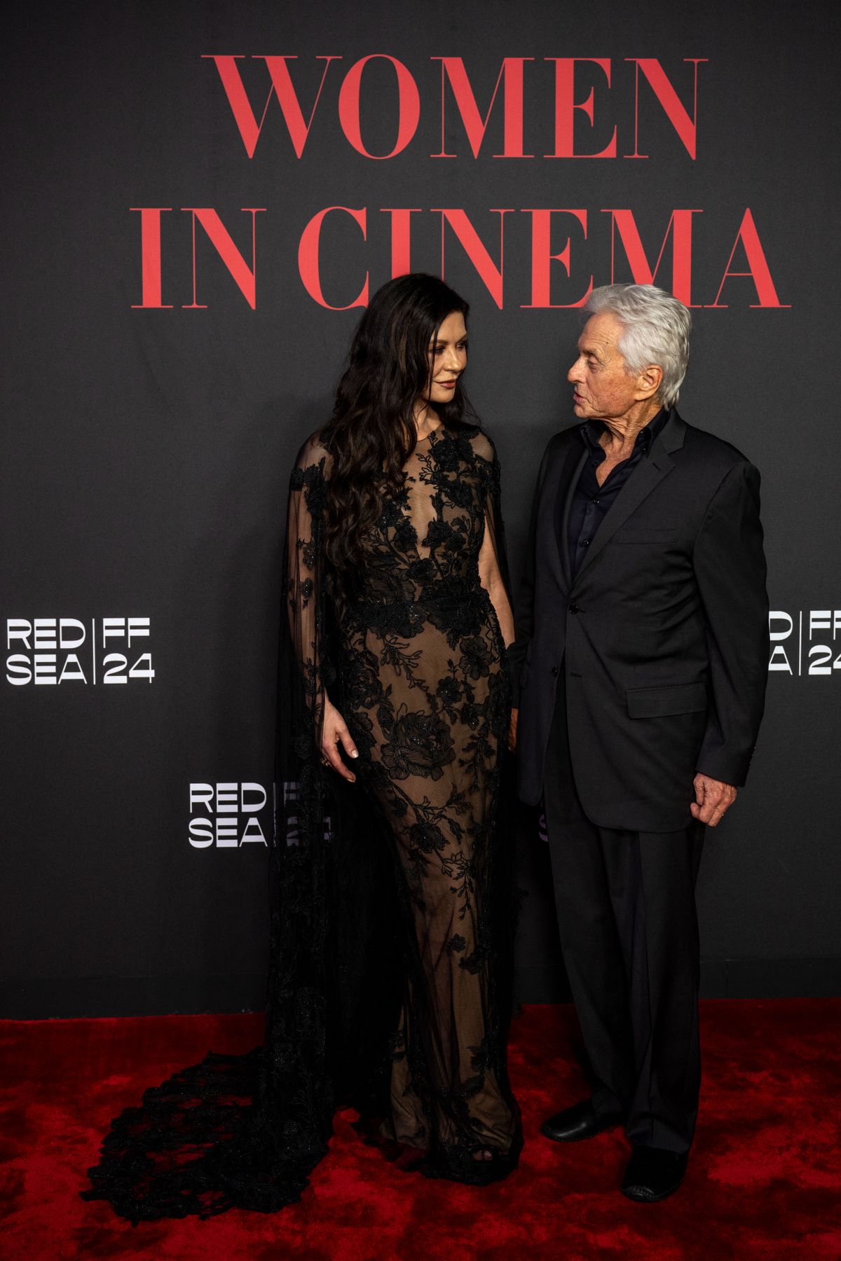 Welsh actress Catherine Zeta-Jones and her husband Michael Douglas pose during the Women in Cinema event at the Jeddah Yacht Club, during the 4th edition of the Red Sea International Film Festival on December 06, 2024. (Photo by AMMAR ABD RABBO / Red Sea Film Festival / FACTSTORY)