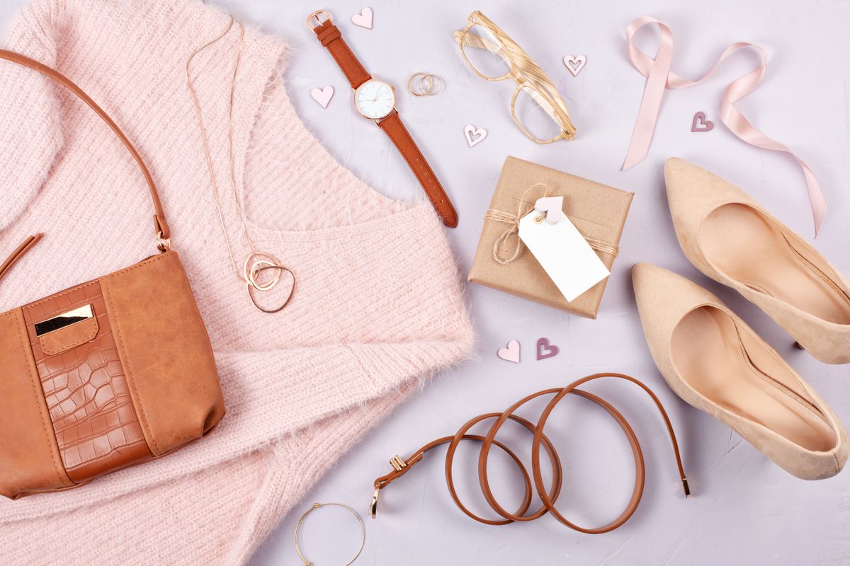 Flat lay of woman clothing and accessories in pastel colors. Modern classic style concept