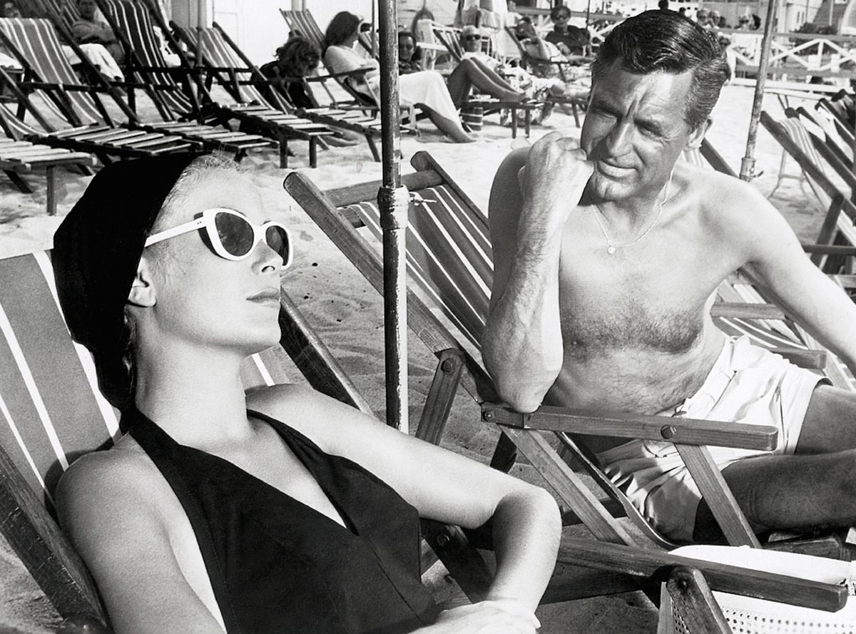 Cary Grant and Grace Kelly lounging on the beach in a scene from the 1955 classic To Catch a Thief. (Photo by George Rinhart/Corbis via Getty Images)