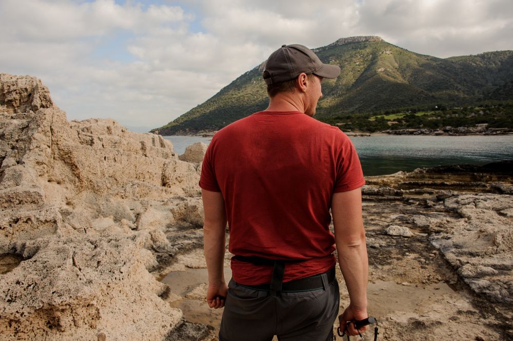Shot of a man in a red shirt with wide shoulders from the back