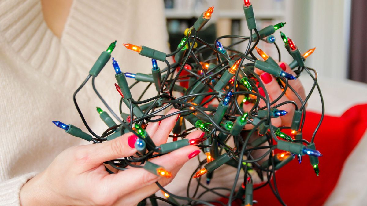 Woman holds colorful Christmas lights